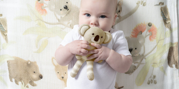 two cute babies wearing nordic print hooded bath towels
