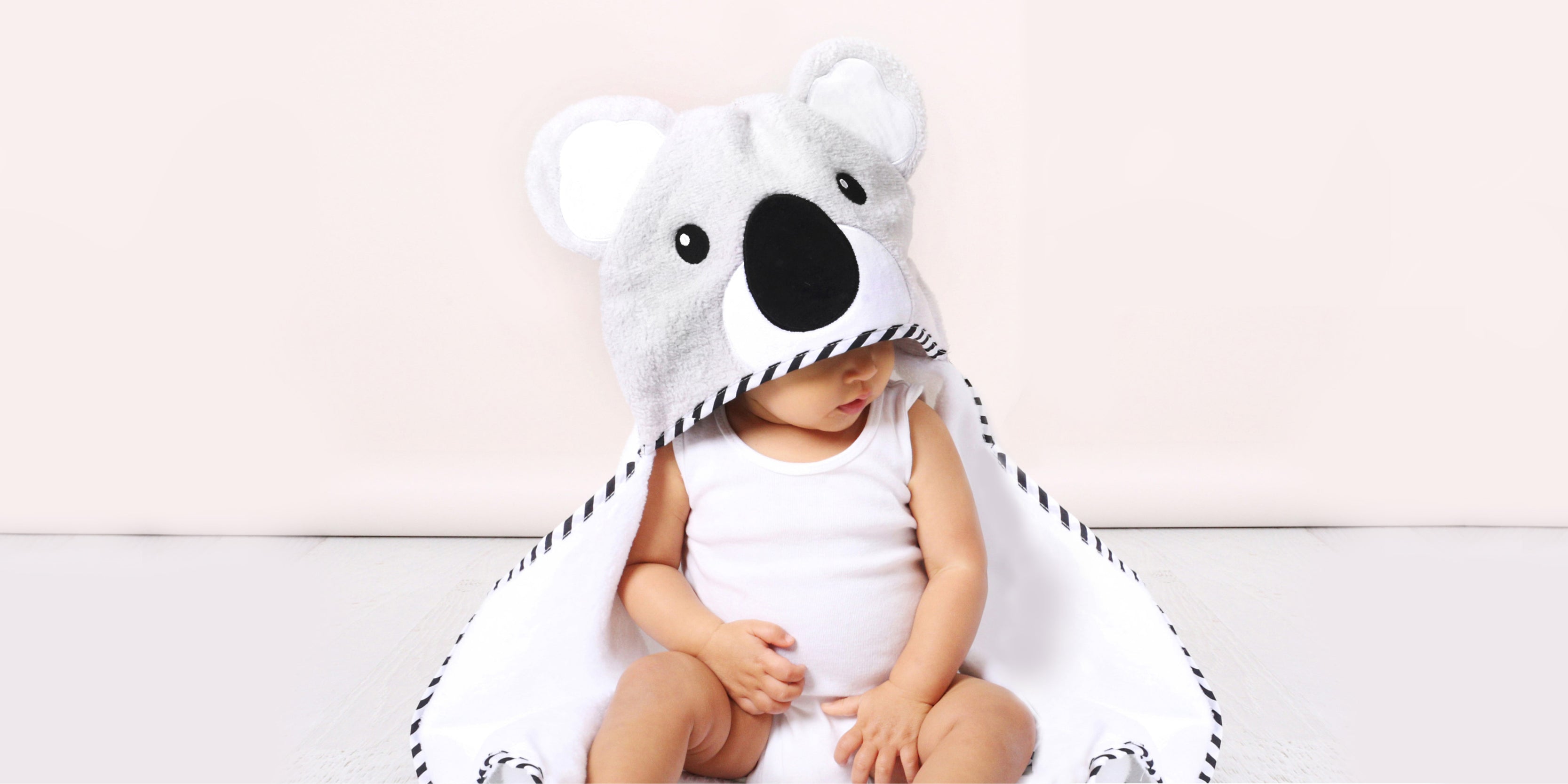 cute baby wearing a koala hooded towel