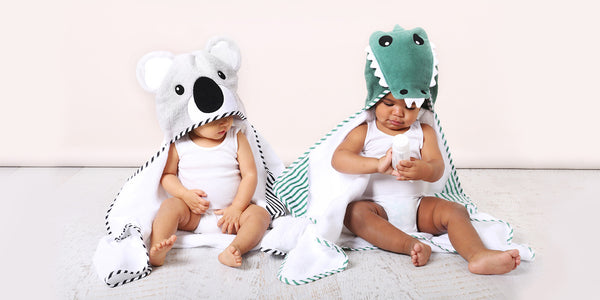 two babies wearing a koala and crocodile hooded baby bath towel