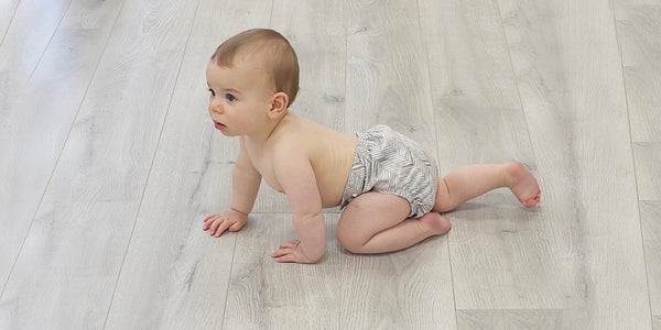 baby crawling with a reusable nappy