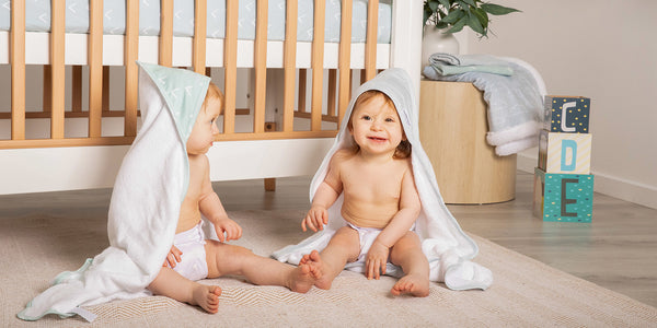 two cute babies wearing nordic inspired print hooded towels