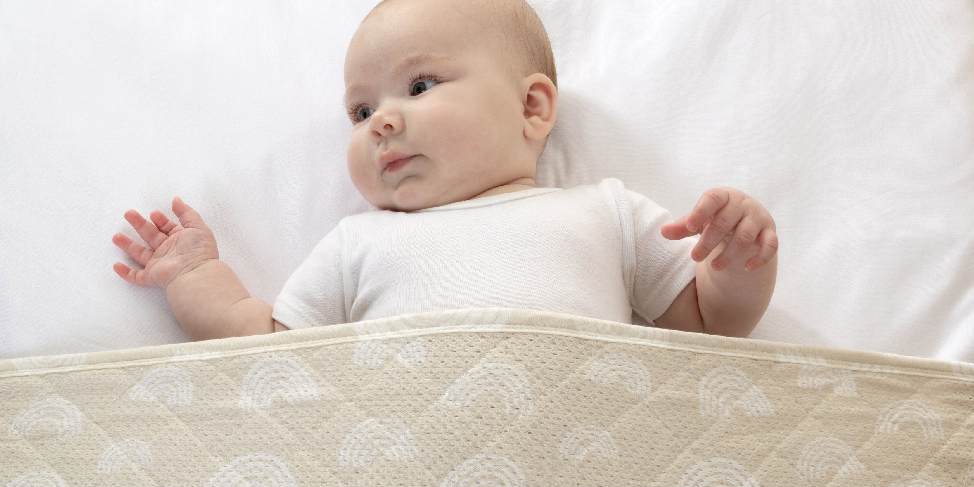 baby in cot using a sleep pouch